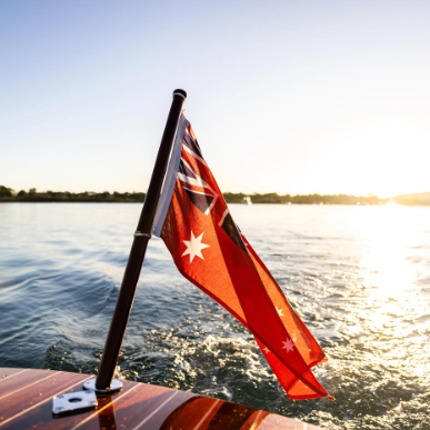 Red Ensign on a boat with a sunset in the background