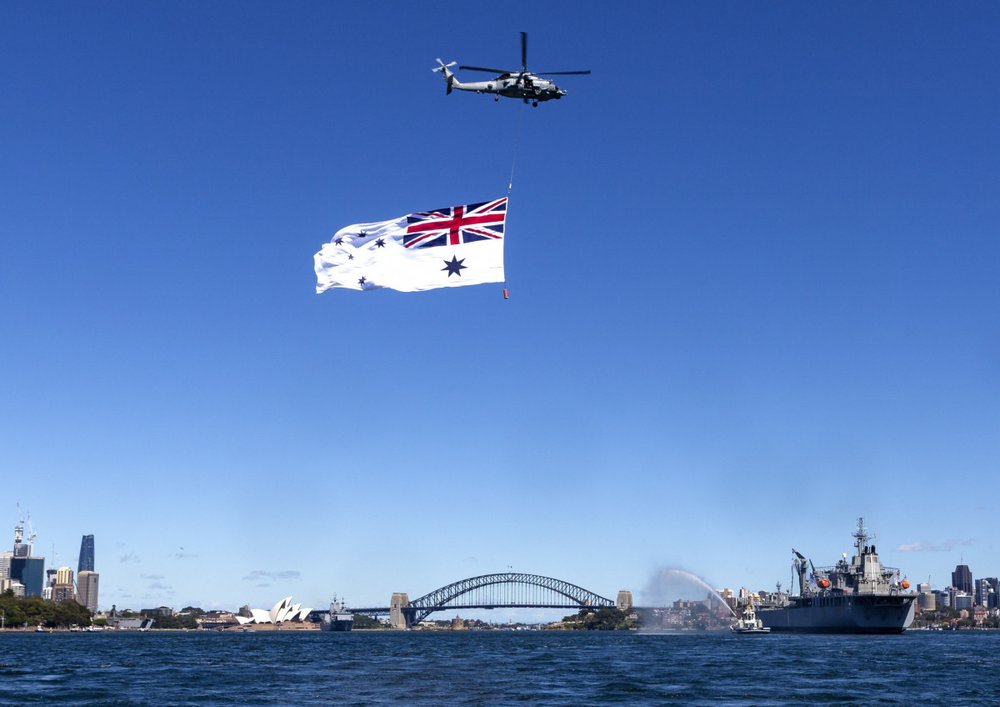 Huge White Ensign Flag flying under a helicopter