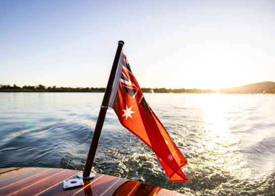 Red Ensign on a boat with a sunset in the background