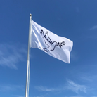 White flag with a navy outline of dove with olive branchin mouth  against a blue sky with some clouds