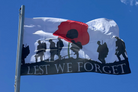 Lest we forget flag flying on pole