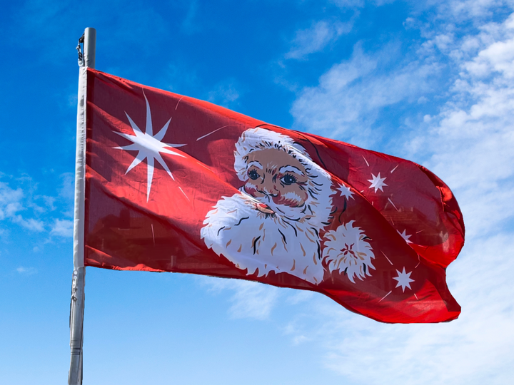 Santa flag flying on flag pole